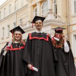 low-angle-happy-graduated-students